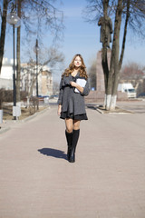 Fototapeta premium Schoolgirl walking on spring sunny street