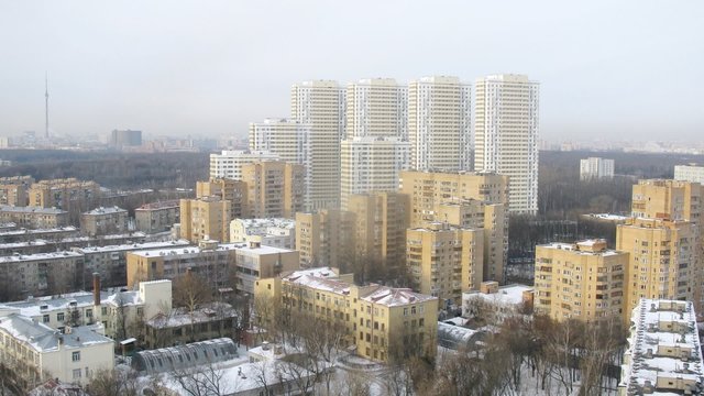 Aerial view of a snowed city in the morning, zoom, timelapse