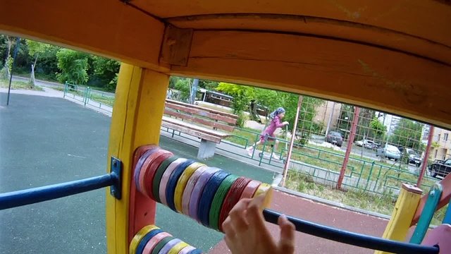 Boy accounts on toy abacus on playground