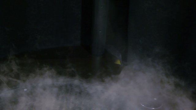 Cloud of smoke forms tornado and raise up in dark tube