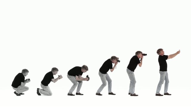 Man takes photographs of evolving self with progressively newer cameras, ultimately using a phone to snap his own portrait, symbolizing the evolution of photography.  Clip tinted from monochrome for oldest camera to color.