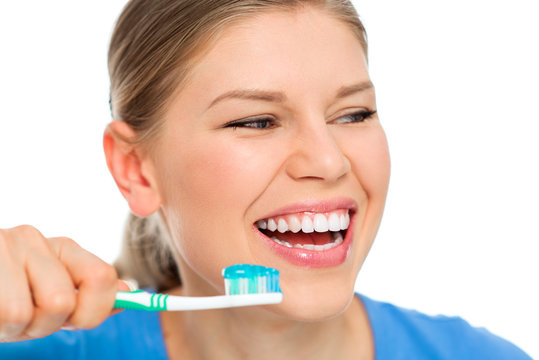 Portrait of happy smiling female holding brush with toothpaste