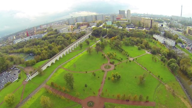 Day view: modern city with aqueduct in cloudy day, aerial view