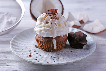 Delicious coconut cupcake with cream and chocolate chips