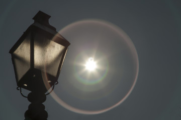 Solar eclipse and vintage street lamp