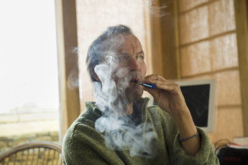 A man using an electronic cigarette, vaping. 