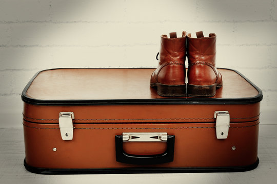 Vintage suitcase with male shoes