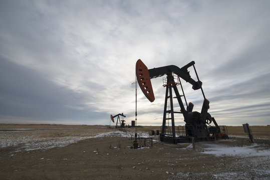 An oil pump jack at a drilling site for oil, an oil field in Saskatchewan.