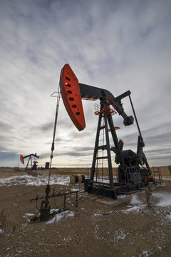 An oil pump jack at a drilling site for oil, an oil field in Saskatchewan.