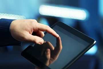Male hand touching screen tablet close-up