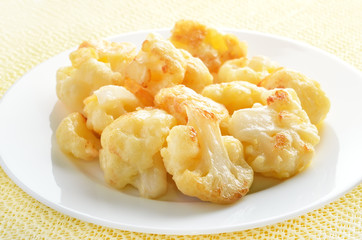 Fried cauliflower on white plate