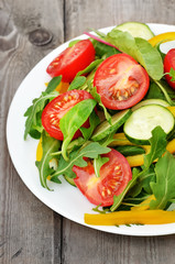 Vegetable salad on rustic table, close up view
