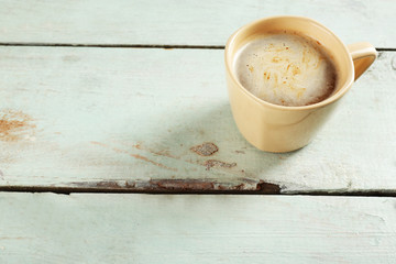Cup of cocoa on color wooden planks background