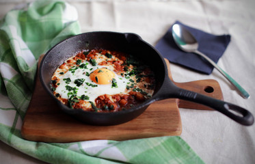 Poached egg in tomato sauce, traditional arabic shakshouka
