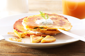 Stack of corn tortillas with stuffing and glass of juice