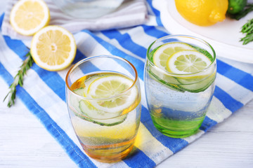 Fresh water with lemon and cucumber in glassware