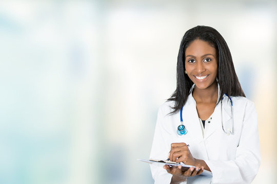 confident happy female doctor medical professional writing notes