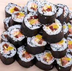 sushi fresh maki rolls isolated on wooden board
