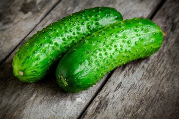 two organic cucumbers  closeup on a rustic background