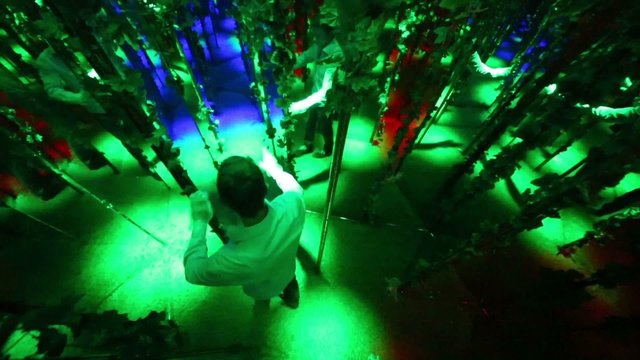 Man walks around a pole in labyrinth illuminated stroboscopic