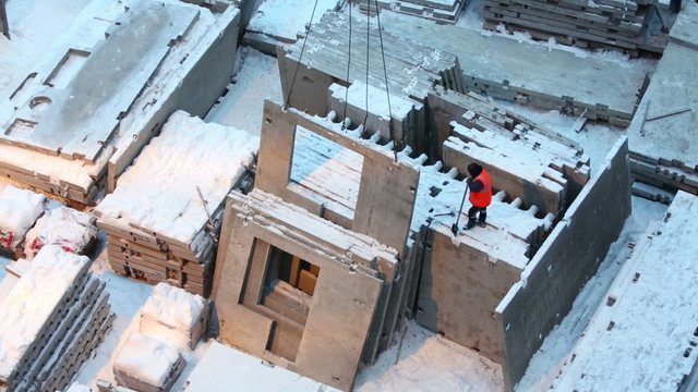 Slings pull out concrete slab from pile at construction site.