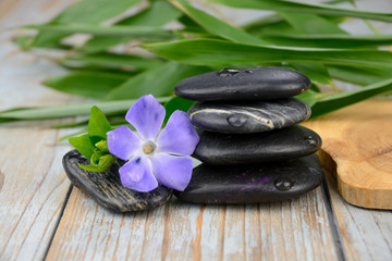 Fototapeta na wymiar Black warmth zen stones decoration on old wooden background