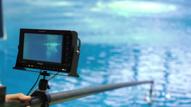 Hand holds camera, monitor which displays jump of sportsman