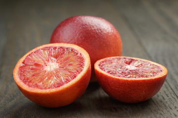 red sicilian oranges sliced on wooden table
