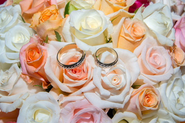 Wedding rings in a bouquet of roses.