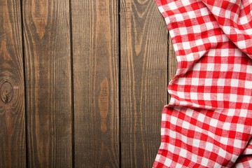 Top. old wooden table with red picnic tablecloth and copyspace
