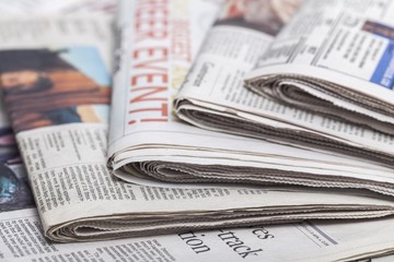 Article. newspapers against plain background shot with very