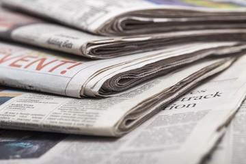 Article. newspapers against plain background shot with very