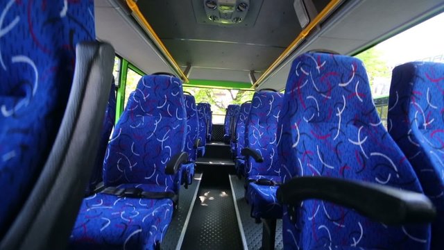 Soft seats for passengers inside saloon of empty city bus