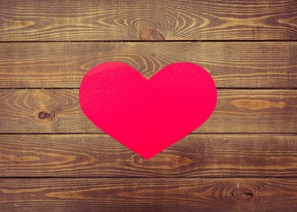 Friday. Love Wednesday on red heart shape with wooden wall with
