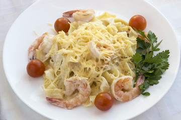 Pasta with prawns and cherry tomatoes.