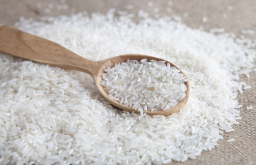close up of rice in a wooden spoon