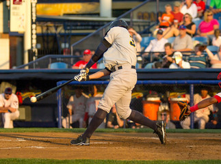 baseball player hitting a pitch