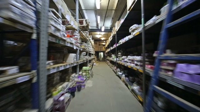 Large warehouse with shelves full of colored flowerpot 