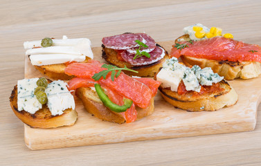 Tapas with cheese, salami and salmon