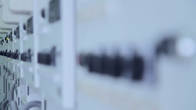 Control cabinets at an electrical substation stand in a row