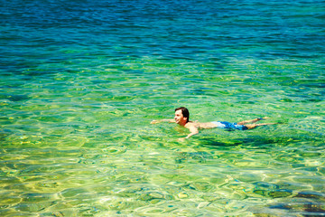 Man Swiming in Crystal Clear Sea