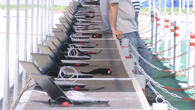 Laptops stand on tables before competitions on firing on pentathlon, time lapse