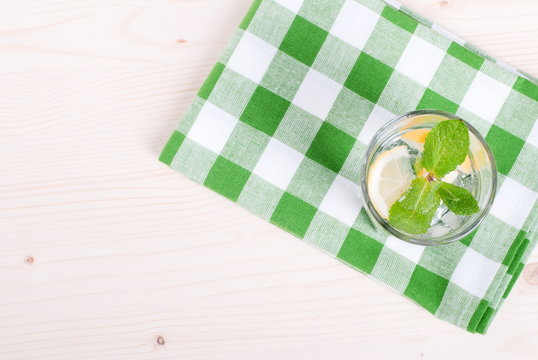 water with lemon and mint in a glass on the table top viewew