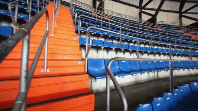 Panorama of blue grandstand with stairs at football stadium