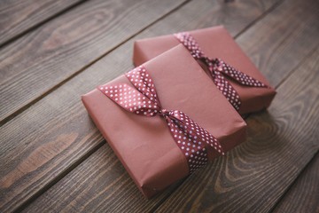 Gift. two elegant gift boxes on a wooden background