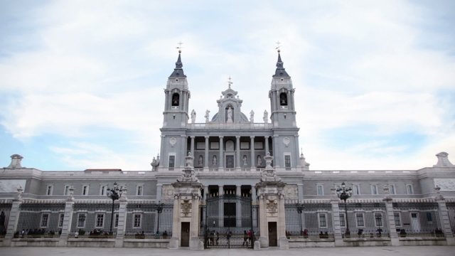 People walk near Cathedral of Nuestra Senora de la Almudena