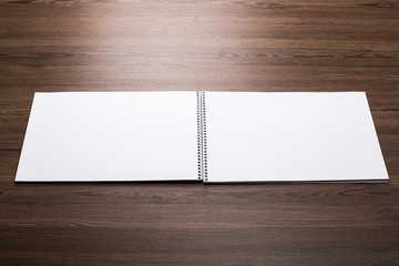 White. Blank. Booklet isolated on wooden textural background