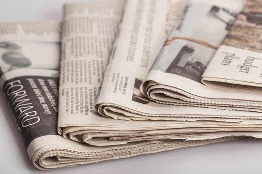 Article. newspapers against plain background shot with very