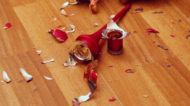 Girls hand arranges toy fragments on parquet floor