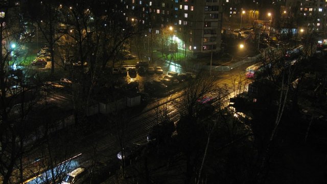 Night city: tramway and car traffic. Timelapse